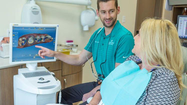 Dentist explaining CEREC to patient